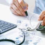 Hand of doctor using a calculator
