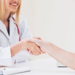 Doctor shake hand with patient in the hospital.
