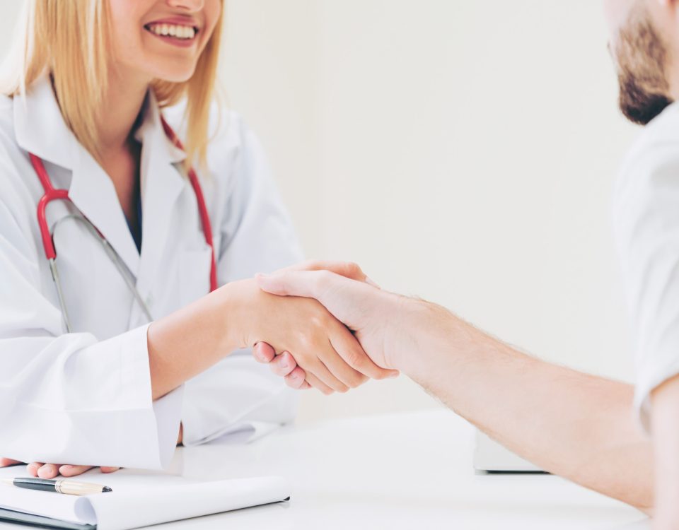 Doctor shake hand with patient in the hospital.