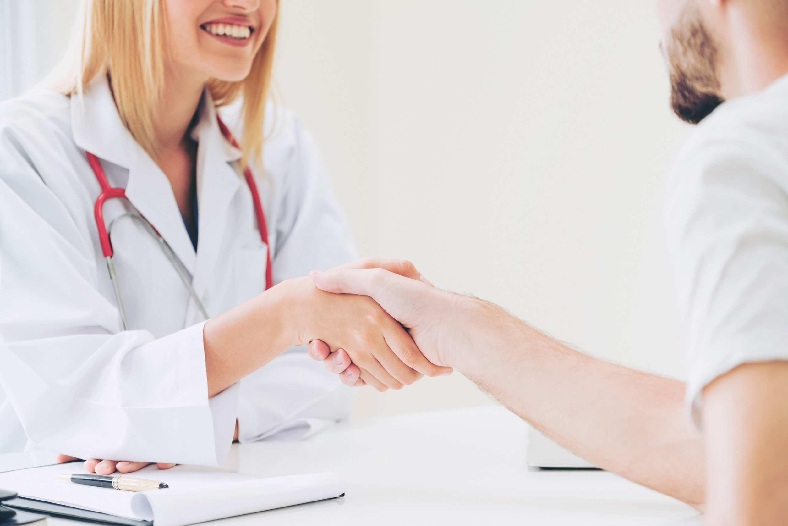 Doctor shake hand with patient in the hospital.