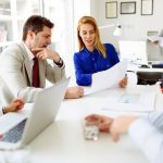 Business people looking at paper with indiana small-group health insurance plans