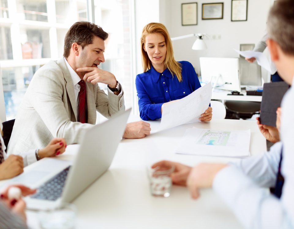 Business people looking at paper with indiana small-group health insurance plans