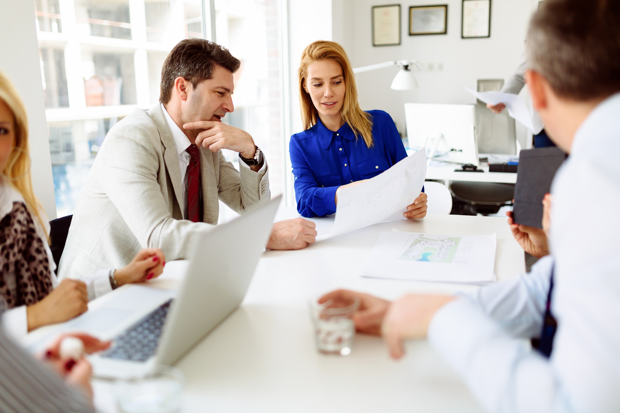 Business people looking at paper with indiana small-group health insurance plans