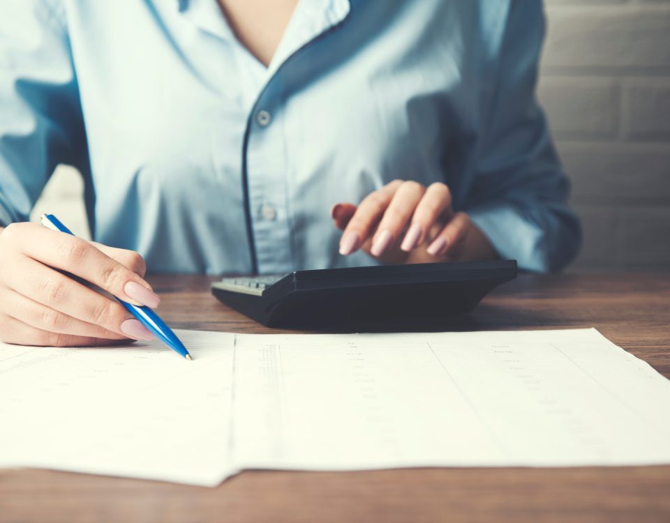 businesswoman hand document and calculator on office desk