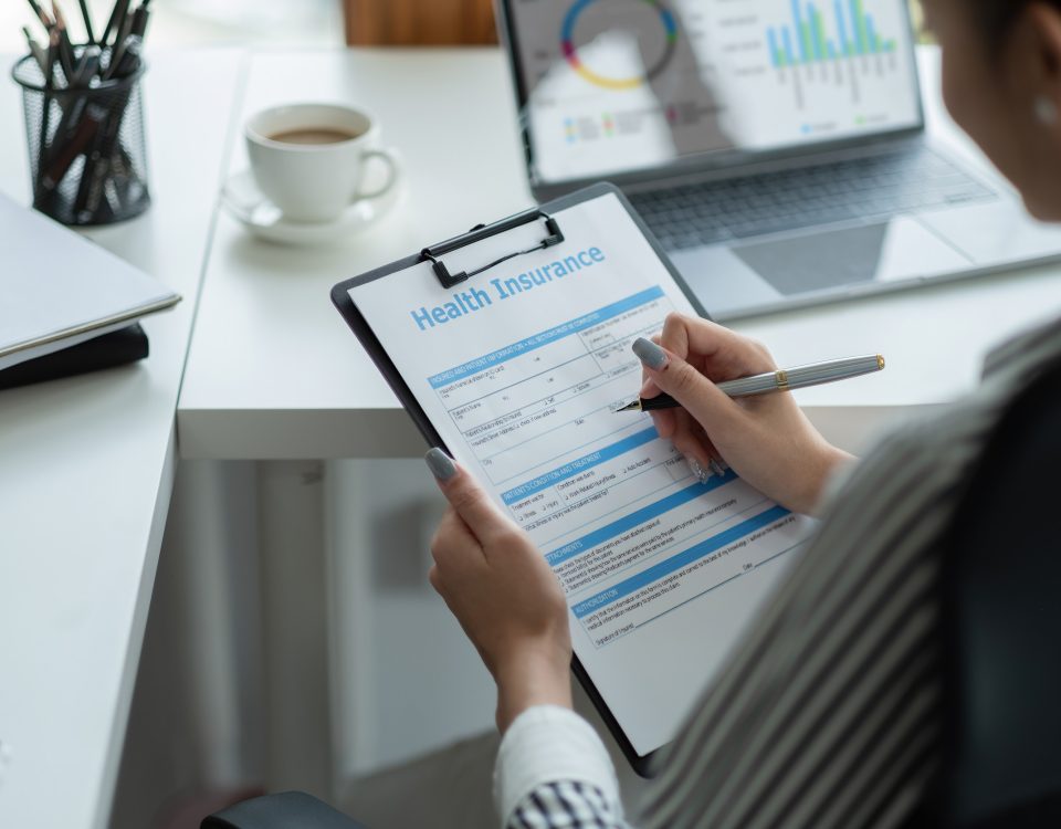 Woman filling out paperwork for small business health insurance